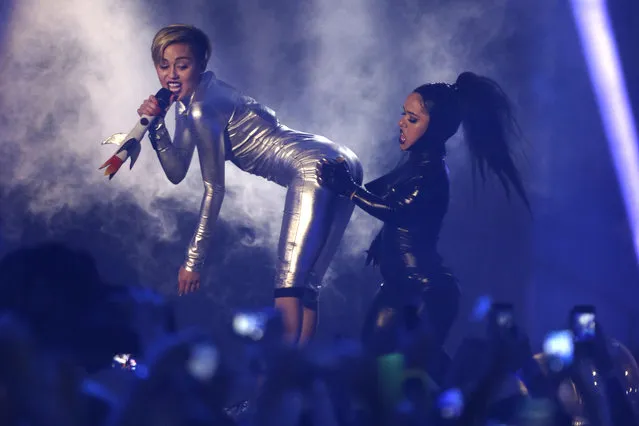 Miley Cyrus, left, and a dancer perform at the 2013 MTV Europe Music Awards in Amsterdam, Netherlands, Sunday, November 10, 2013. (Photo by Peter Dejong/AP Photo)