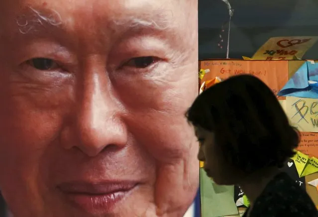 A woman passes a picture of former Singaporean prime minister Lee Kuan Yew, placed at a well-wishing corner at the Singapore General Hospital in Singapore March 23, 2015. Lee, Singapore's first prime minister and architect of the tiny Southeast Asian city-state's rapid rise from British tropical outpost to global trade and financial centre, died early on Monday, aged 91, the Prime Minister's Office said. (Photo by Edgar Su/Reuters)