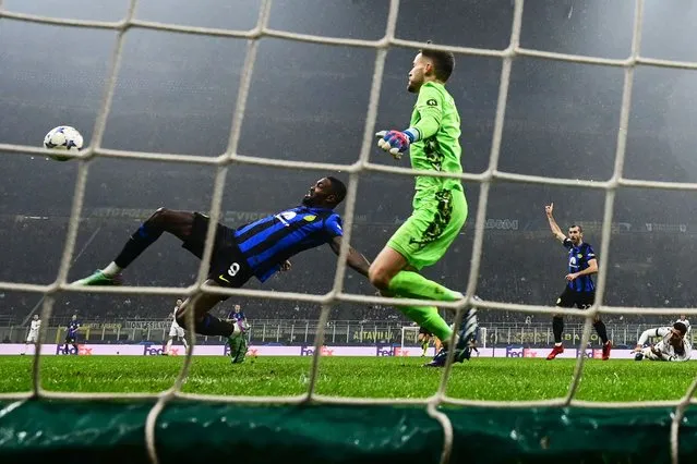 Inter Milan's French forward #09 Marcus Thuram (L) shoots the ball during the UEFA Champions League 1st round day 6 Group D football match between Inter Milan and Real Sociedad at the San Siro stadium in Milan on December 12, 2023. (Photo by Marco Bertorello/AFP Photo)