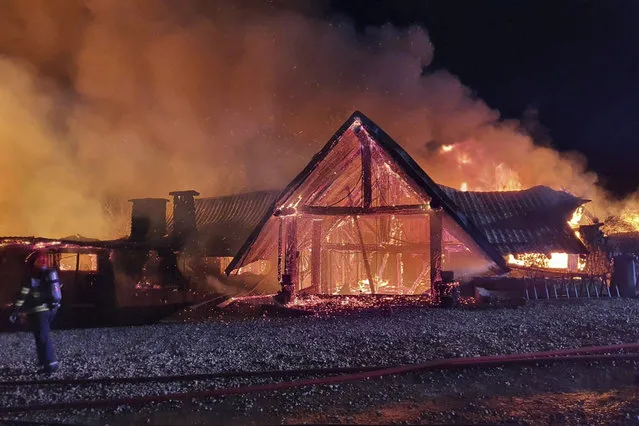 In this photo released by the Romanian Emergency Services Prahova (ISU Prahova), a guesthouse is in flames, in Tohani, Romania, Tuesday, December 26, 2023. A huge fire at a guesthouse in Romania on Tuesday morning has left several people dead, including a child, and some people are missing, authorities said. (Photo by Romanian Emergency Services – ISU Prahova via AP Photo)