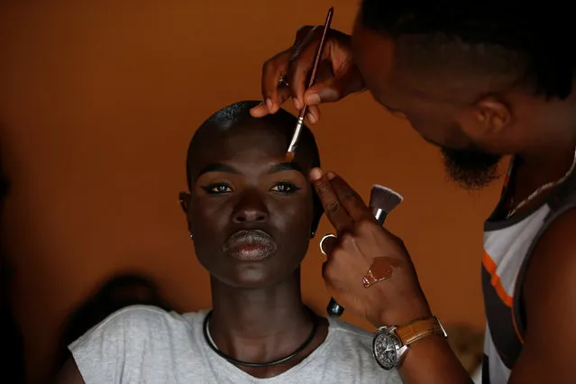 A Kenyan model Ajuma Nasanyana goes through a make up behind the scenes of a fashion show featuring African fashion and culture, during a gala marking the launch of a book called “African Twilight: The Vanishing Rituals and Ceremonies of the African Continent” at the African Heritage House in Nairobi, Kenya on March 3, 2019. (Photo by Baz Ratner/Reuters)