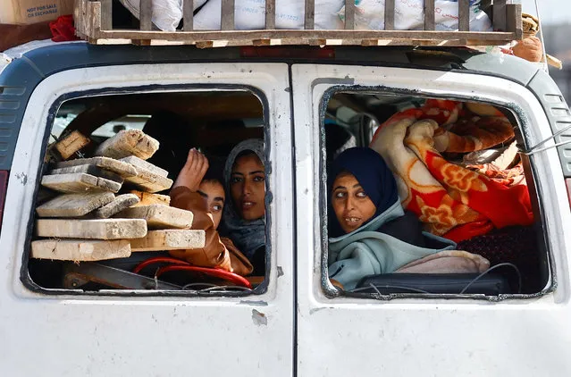 Palestinian women fleeing Khan Younis, due to the Israeli ground operation, move towards Rafah, amid the ongoing conflict between Israel and the Palestinian Islamist group Hamas, in the southern Gaza Strip, on January 28, 2024. (Photo by Ibraheem Abu Mustafa/Reuters)