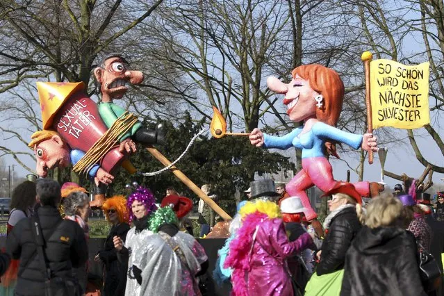 A carnival float with papier-mache caricatures featuring a woman lighting up a rocket with two men chained to it alluding to the sexual assaults in New Year's Eve, is displayed at a postponed “Rosenmontag” (Rose Monday) parade, at one location in Duesseldorf, Germany, March 13, 2016, after the original parade in February was cancelled due to severe weather. (Photo by Ina Fassbender/Reuters)