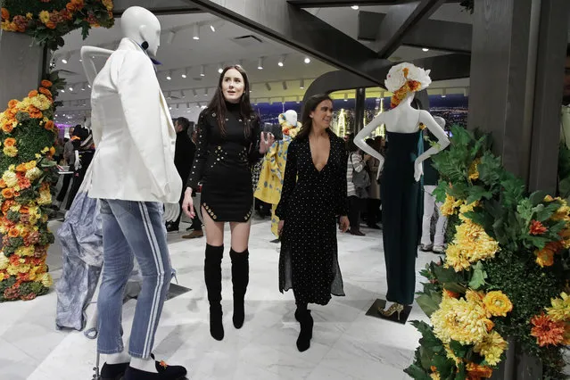 In this March 14, 2019, file photo women shop at Neiman Marcus during the opening night of The Shops & Restaurants at Hudson Yards in New York. On Monday, April 1, the Commerce Department releases U.S. retail sales data for February. (Photo by Mark Lennihan/AP Photo/File)