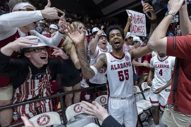 Alabama guard Aaron Estrada (55) celebrates with fans after the team's win over Florida in overtime in an NCAA college basketball game Wednesday, February 21, 2024, in Tuscaloosa, Ala. (Photo by Vasha Hunt/AP Photo)