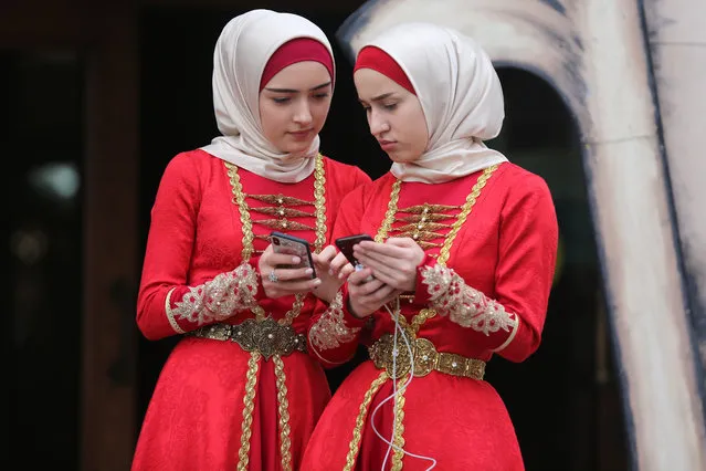 Two girls in traditional costumes during celebrations marking Day of the Chechen Language in Grozny, Chechnya, Russia on April 25, 2019. (Photo by Yelena Afonina/TASS)