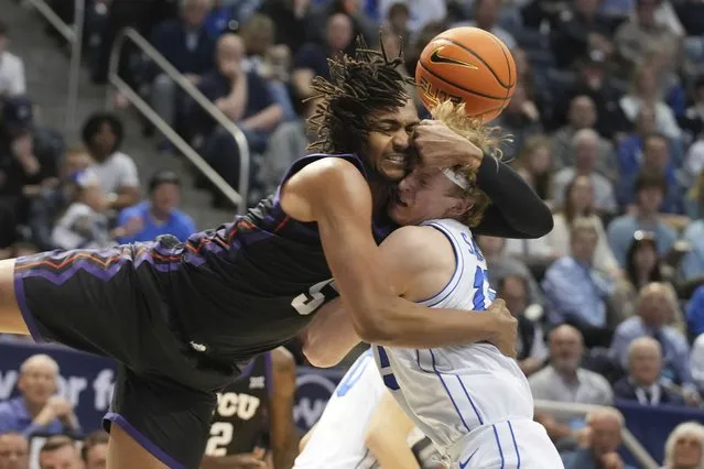 TCU forward Chuck O'Bannon Jr. (5) and BYU guard Richie Saunders (15) fight for a loose ball during the first half of an NCAA college basketball game Saturday, March 2, 2024, in Provo, Utah. (Photo by George Frey/AP Photo)