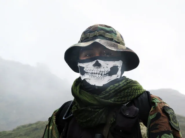 In this February 28, 2015 photo, an elite policeman of the DIRANDRO counternarcotics police agency walks through a puna or highland plane in Husnay, Peru, after an unsuccessful mission to try to arrest drug-toting backpackers hiking up from the world's No. 1 cocaine-producing region. The backpackers can choose from myriad routes in a half dozen corridors of sparsely populated steppe. They often hike at night, to avoid detection. Few know before they are arrested that they face eight- to 15-year prison sentences. (Photo by Rodrigo Abd/AP Photo)