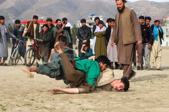 Afghan traditional wrestlers compete at a field in Fayzabad on March 10, 2024. (Photo by Omer Abrar/AFP Photo)