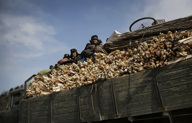 North Korean soldiers ride in a truck carrying firewood on Saturday, February 20, 2016, in Wonsan, North Korea. (Photo by Wong Maye-E/AP Photo)