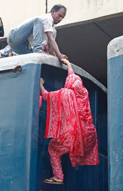 Bangladeshi people climb into the roof of an overcrowded train as they travel to celebrate Eid with family in their villages, at the Kamlapur Railway Station in Dhaka, Bangladesh, 03 June 2019. Muslims around the world are preparing to celebrate Eid al-Fitr, the three-day festival marking the end of the Muslim holy month of Ramadan, Eid al-Fitr is one of the two major holidays in Islam. (Photo by Monirul Alam/EPA/EFE)