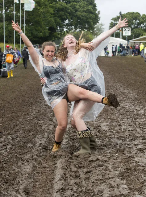 Festival goers wearing waterproof ponchos pose for a photograph at Isle of Wight Festival 2019 at Seaclose Park on June 13, 2019 in Newport, Isle of Wight (Photo by Mark Holloway/Redferns)