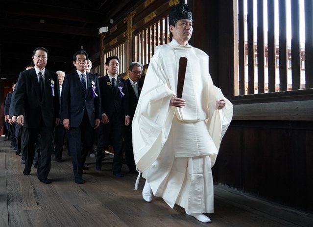 A Shinto priest leads Japanese lawmakers during a visit to the controversial Yasukuni Shrine at the end of the spring festival, in Tokyo on April 23, 2024. (Photo by Kazuhiro Nogi/AFP Photo)