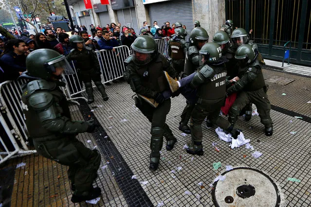 A student protester is detained outside the education ministry building during a rally to demand changes in the education system in Santiago, Chile April 28, 2016. (Photo by Ivan Alvarado/Reuters)