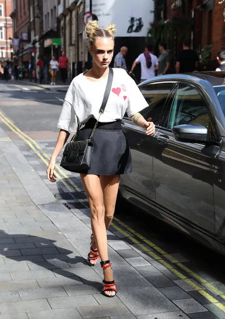 Actress and model Cara Delevingne arrives at hotel in a mini skirt and Queen of Hearts t-shirt in London, England on August 28, 2019. (Photo by Splash News and Pictures)