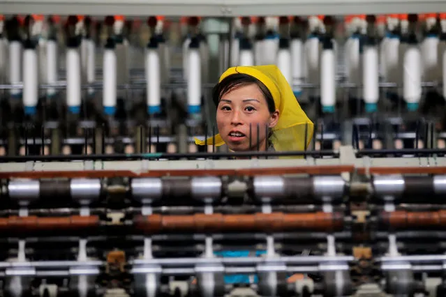 A woman works at the Kim Jong Suk Pyongyang textile mill during a government organised visit for foreign reporters in Pyongyang, North Korea May 9, 2016. (Photo by Damir Sagolj/Reuters)