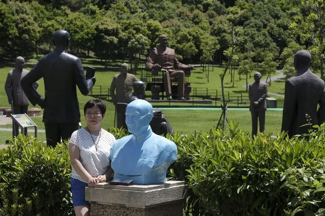A woman poses for a photo next to a statue of the late president and Nationalist leader Chiang Kai-shek in Taoyuan, nothern Taiwan, July 5, 2015. (Photo by Pichi Chuang/Reuters)