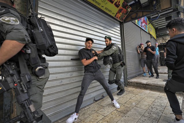 Israeli police push away Palestinians from a street in the Muslim Quarter of Jerusalem's Old City, shortly before a march through the area by Jewish nationalists, Thursday, May 18, 2023. The parade was marking Jerusalem Day, an Israeli holiday celebrating the capture of east Jerusalem in the 1967 Mideast war. Palestinians see the march as a provocation. (Photo by Ohad Zwigenberg/AP Photo)