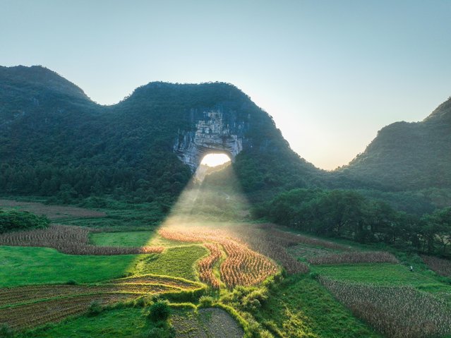 Aerial view of sunbeam shining through mountain cave at Yueyan National Forest Park on August 27, 2024 in Yongzhou, Hunan Province of China. (Photo by Jiang Keqing/VCG via Getty Images)