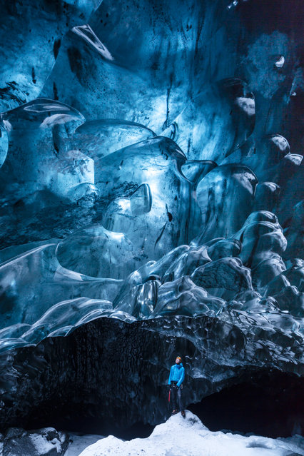 “Ice World”. Ice cave – deep under the Jokulsarlon glacier, Iceland. Natural light is coming through a crevasse at the surface, illuminating this underworld of compressed ice – in most parts 30 metres thick. Photo location:  Iceland. (Photo and caption by Timo Lieber/National Geographic Photo Contest)