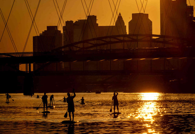 People paddle over the river Main in Frankfurt, Germany, as the sun sets on Monday, August 26, 2024. (Photo by Michael Probst/AP Photo)