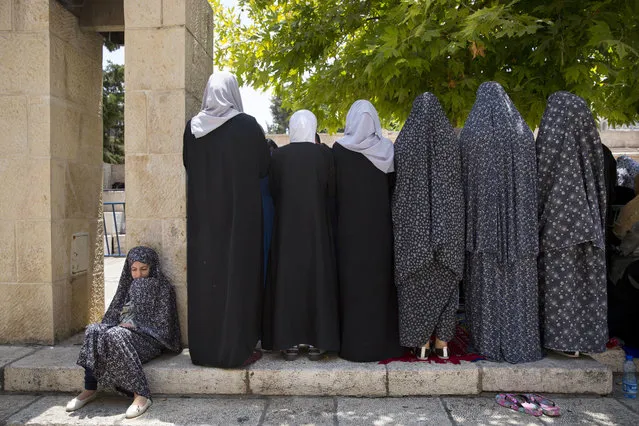 Palestinians women pray at the Lion's Gate following an appeal from clerics to pray in the streets instead of inside the Al Aqsa Mosque compound, in Jerusalem's Old City, Tuesday, July 25, 2017. Dozens of Muslims have prayed in the street outside a major Jerusalem shrine, heeding a call by clerics not to enter the site until a dispute with Israel over security arrangements is settled. This comes after Israel removed metal detectors earlier on Tuesday. (Photo by Oded Balilty/AP Photo)