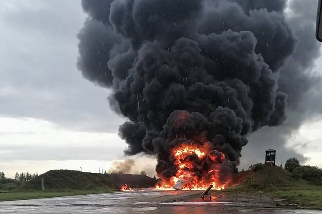 In this image released by Sirena telegram channel on Sunday, August 20, 2023, a Russian warplane is burning on the Soltsy air base in the Novgorod region in northwestern Russia. Ukrainian saboteurs coordinated by Kyiv's military intelligence services carried out a pair of recent drone attacks that hit parked bomber aircraft at air bases deep inside Russia, Ukraine media claimed Tuesday. The attacks on Russian airfields on Saturday and Monday destroyed two Russian bombers and damaged two other aircraft, according to Ukrainska Pravda, as the war approaches its 18-month milestone. (Photo by Sirena telegram channel via AP Photo)