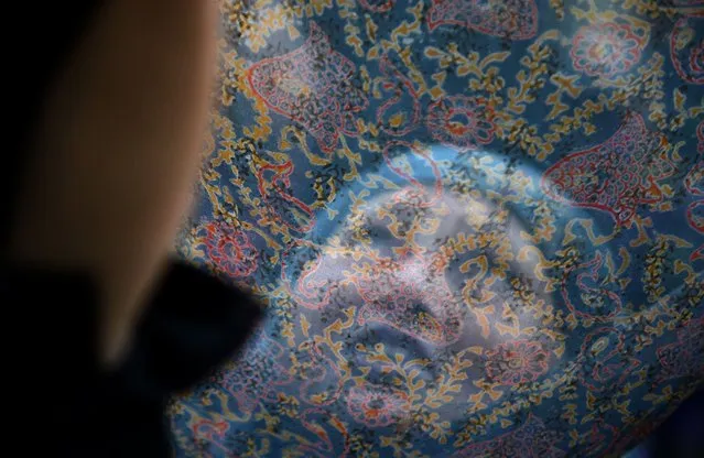 Kashmiri Muslims pray as an unseen custodian displays a holy relic, believed to be a hair from the Prophet Muhammad's beard, during the last Friday of celebrations for Miraj-Ul-Alam (Ascension to Heaven) at Kashmir's main Hazratbal Shrine in Srinagar on May 22, 2015. (Photo by Tauseef Mustafa/AFP Photo)