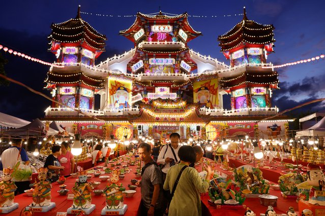 People prepare for the annual Hungry Ghost Festival prayer in Keelung, Taiwan on August 30, 2023. (Photo by Ann Wang/Reuters)