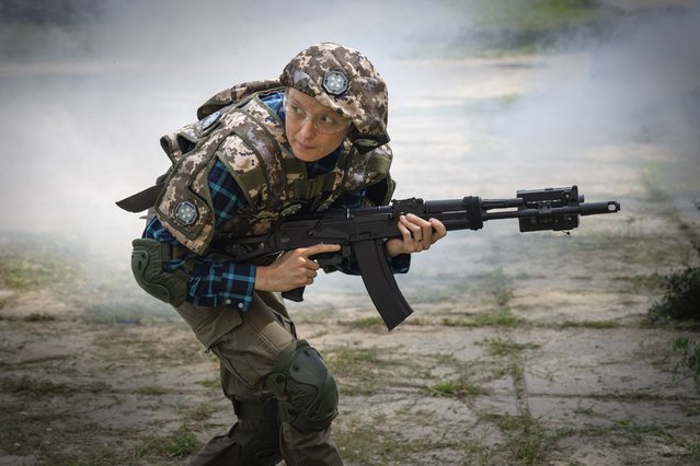 A woman practices during volunteer military training for civilians close to Kyiv, Ukraine, Friday, August 11, 2023. (Photo by Efrem Lukatsky/AP Photo)