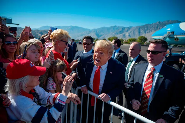 US President Donald Trump speaks with supporters as he arrives in Palm Springs, California, on February 19, 2020. (Photo by Jim Watson/AFP Photo)