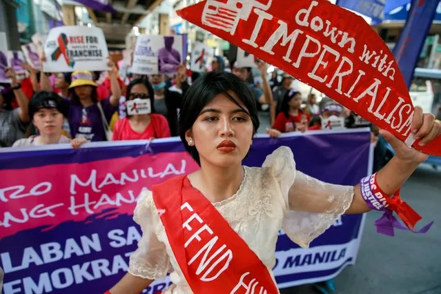 An activist holds a placard as Filipino women march during a protest on International Women's Day in Manila, Philippines, March 8, 2020. (Photo by Eloisa Lopez/Reuters)