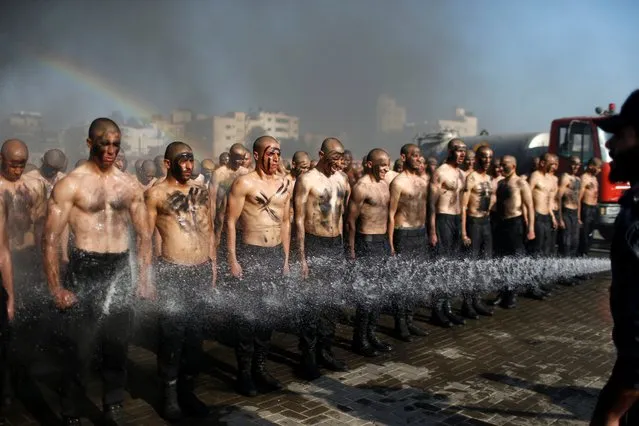 Palestinian police recruits loyal to Hamas are sprayed with water as they demonstrate their skills during a training session at a police academy in Gaza City on January 30, 2020. (Photo by Mohammed Salem/Reuters)