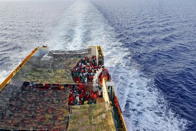 Migrants crowd the bridge of the Norwegian Siem Pilot ship sailing along the Mediterranean sea, Wednesday, September 2, 2015. The Siem Pilot is carrying to the Italian Port of Cagliari hundreds of migrants rescued in several operations in the Mediterranean sea. (Photo by Gregorio Borgia/AP Photo)