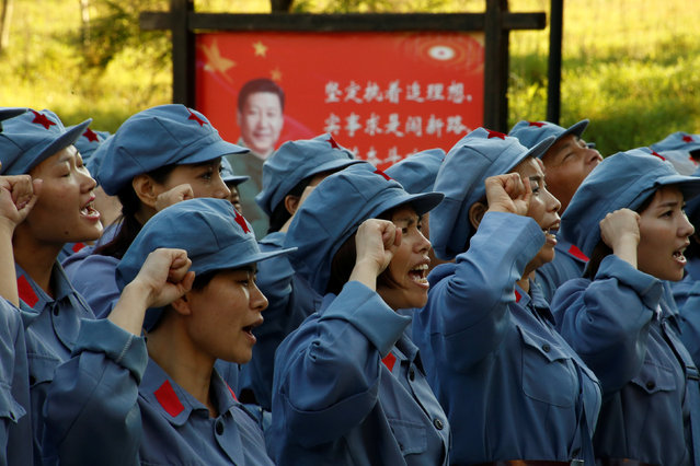 Participants dressed in replica red army uniforms swear an oath during a Communist team-building course extolling the spirit of the Long March in the mountains outside Jinggangshan, Jiangxi province, China, September 14, 2017. (Photo by Thomas Peter/Reuters)