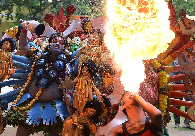 Indian artists perform during the Bonalu festival at the Sri Akkanna Madanna Mahankali Temple in Hyderabad on August 1, 2016. The eleven-day “Bonalu” festival sees ritual offerings of food and dancing made to the  Hindu goddess Maha Kali, who is honoured mainly by women during the event. (Photo by Noah Seelam/AFP Photo)