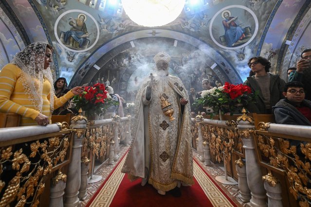 A priest leads Orthodox Christmas Eve celebrations at the Archangel Michael Coptic Orthodox Church in Cairo on January 6, 2025. (Photo by Ahmed Hasan/AFP Photo)