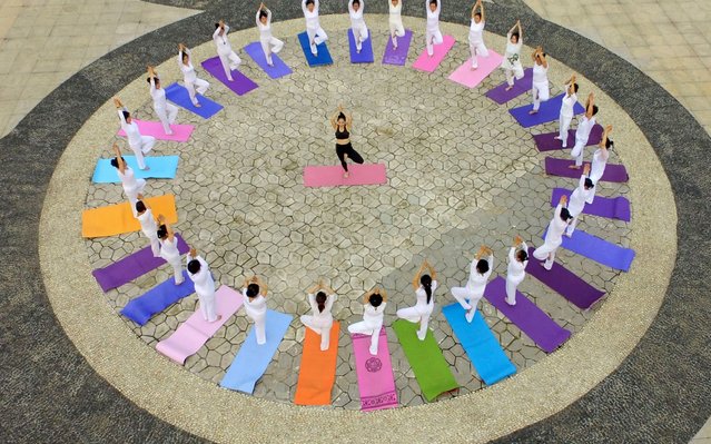 This aerial photo shows yoga enthusiasts practising yoga at a park in Handan in China's northern Hebei province on June 19, 2020, ahead of International Yoga Day celebrated annually on June 21. (Photo by AFP Photo/China Stringer Network)