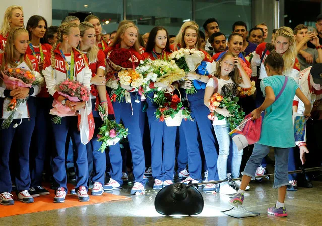 Members of the Russian Olympic team react to a fallen studio lamp during a welcoming ceremony as they return home from the 2016 Rio Olympics, at Sheremetyevo International Airport outside Moscow, Russia, August 23, 2016. (Photo by Maxim Zmeyev/Reuters)