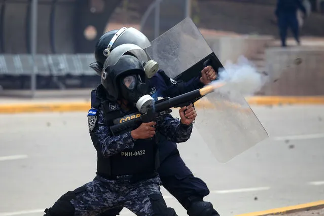 Riot police fires tear gas toward supporters of Salvador Nasralla, presidential candidate for the Opposition Alliance Against the Dictatorship, during a protest while awaiting for official presidential election results in Tegucigalpa, Honduras November 30, 2017. (Photo by Jorge Cabrera/Reuters)