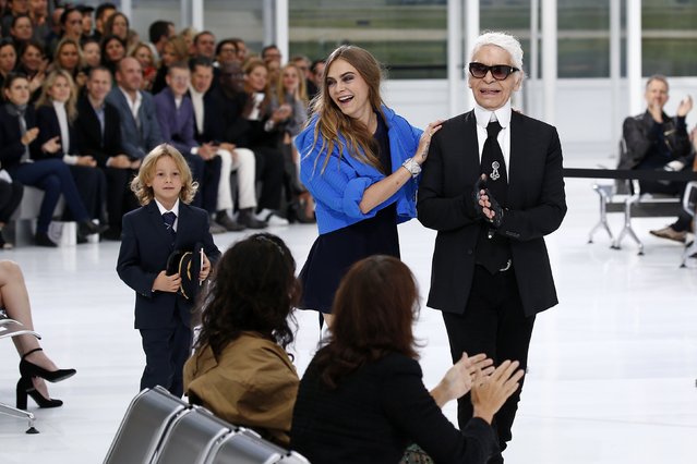 German designer Karl Lagerfeld (R) and model Cara Delevingne appear at the end of his Spring/Summer 2016 women's ready-to-wear collection for fashion house Chanel at the Grand Palais which is transformed into a Chanel airport during Fashion Week in Paris, France, October 6, 2015. (Photo by Benoit Tessier/Reuters)
