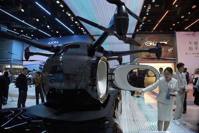 A worker introduces GOVY Air Car from GAC Group displayed at the Shanghai auto show on Thursday, April 24, 2025. (Photo by Ng Han Guan/AP Photo)