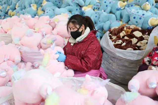 This photo taken on December 15, 2022 shows a worker producing stuffed toys at a factory in Lianyungang, in China's eastern Jiangsu province. (Photo by AFP Photo/China Stringer Network)