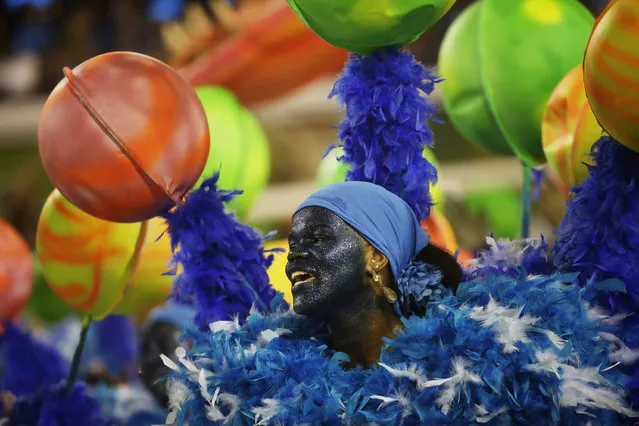 A performer from the Unidos de Vila Isabel samba school parades during Carnival celebrations at the Sambadrome in Rio de Janeiro, Tuesday, February 12, 2013. Rio de Janeiro's samba schools vied for the title of the year's best in an over-the-top, all-night-long Carnival parade at the city's iconic Sambadrome. (Photo by Silvia Izquierdo/AP Photo)