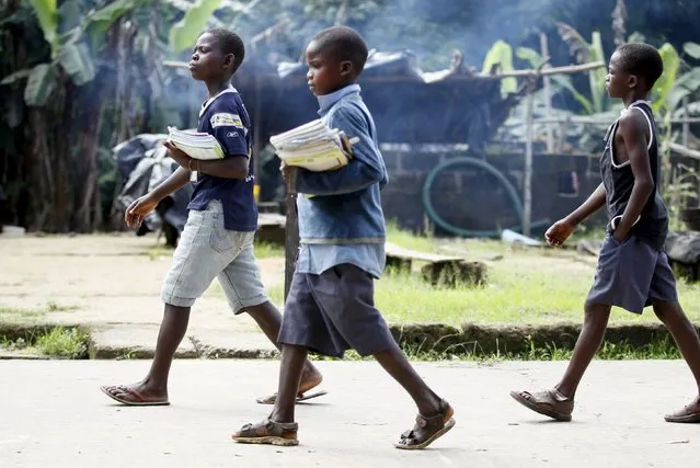 Children return from school in the mid-morning, in Ikarama village on the outskirts of the Bayelsa state capital, Yenagoa, in Nigeria's delta region October 8, 2015. (Photo by Akintunde Akinleye/Reuters)