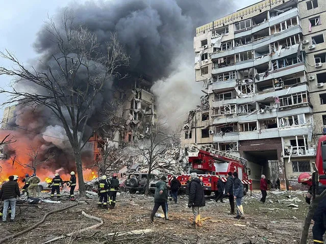 In this photo released by the Ukrainian Presidential Press Office, smoke rises after a Russian rocket hit a multistory building leaving many people under debris in Dnipro, Ukraine, Saturday, January 14, 2023. (Photo by Ukrainian Presidential Press Office via AP Photo)
