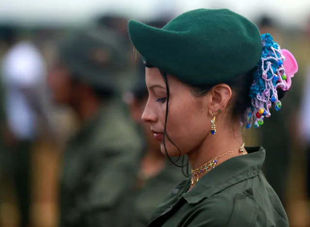 A fighter from Revolutionary Armed Forces of Colombia (FARC) stands in line during the opening of ceremony congress at the camp where they prepare for ratifying a peace deal with the government, near El Diamante in Yari Plains, Colombia, September 17, 2016. (Photo by John Vizcaino/Reuters)