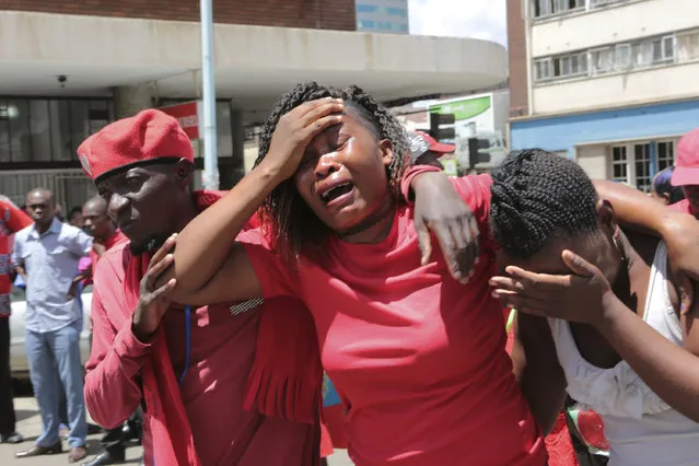 Supporters of Morgan Tsvangirai can hardly hold back their tears outside the party headquarters in Harare, Thursday, February 15, 2018. Zimbabwe's president is expressing condolences over the death of longtime opposition leader Morgan Tsvangirai and says upcoming elections must be free and fair “in tribute to him”. Tsvangirai, who was the boldest opponent to longtime leader Robert Mugabe, died Wednesday in a Johannesburg hospital at age 65 after a long battle with cancer. (Photo by Tsvangirayi Mukwazhi/AP Photo)