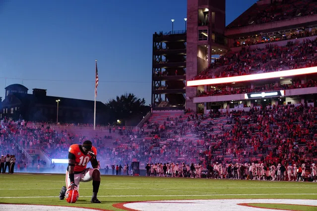 Georgia defensive lineman Malik Herring (10) kneels on the field before an NCAA college football game against Auburn, Saturday, October 3, 2020, in Athens, Ga. (Photo by Brynn Anderson/AP Photo)