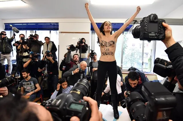 A “Femen” activist stages a bare chested protest against former Italian Prime Minister and leader of the 'Forza Italia' party, Silvio Berlusconi (not in picture) as he arrives for voting in the general elections at a polling station in Milan, Italy, 04 March 2018. Slogon on women's breast reads: “Berlusconi you are expired”. General elections are held in Italy on 04 March 2018 with the country's economic situation and migrant influx in the past years believed to dominate the voters' decisions. The three main political contenders in Italy, the right-wing coalition, the ruling Democratic Party and the anti-establishment 5-Star-Movement have all predicted major results for themselves. The final results of the elections are expected to be announced on early 05 March. (Photo by Daniel Dal Zennaro/EPA/EFE)